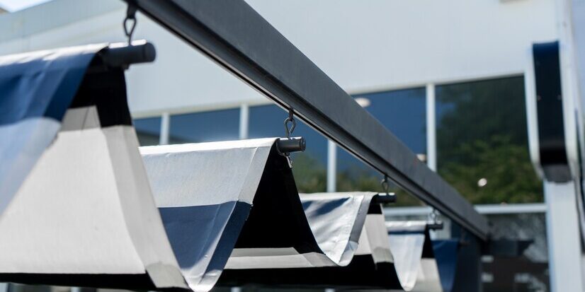 retractable-awning-roof-protect-sun-garden_51665-555 retractable shades for patio