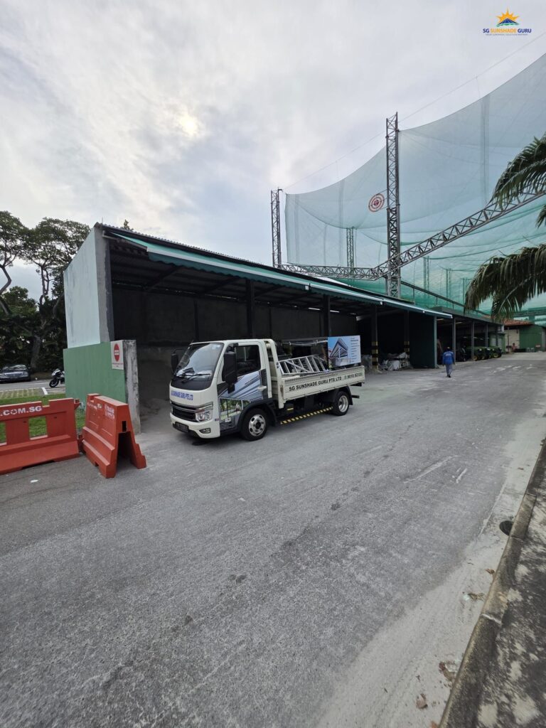 Commercial retractable awning covering a warehouse loading bay with durable weather-resistant fabric in Singapore.