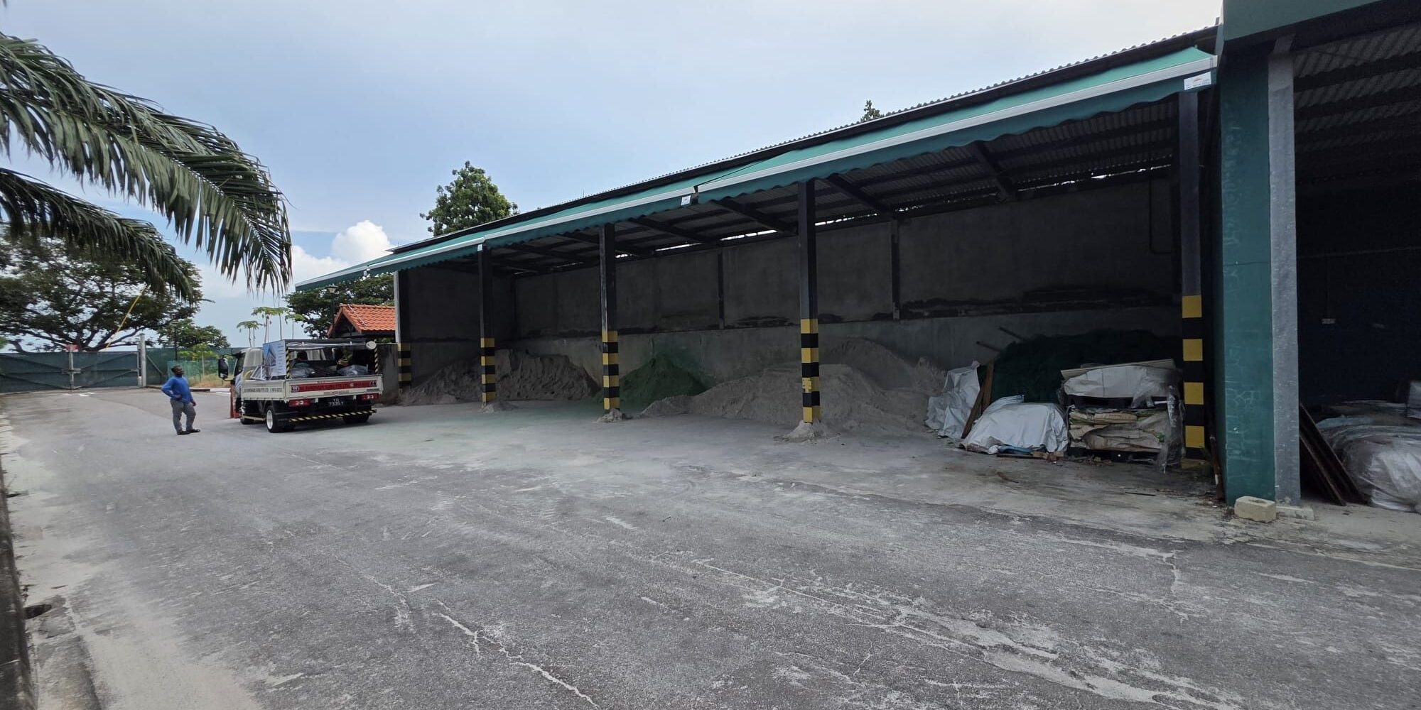 Motorized retractable awning system installed at an industrial facility by SG Sunshade Guru in Singapore.