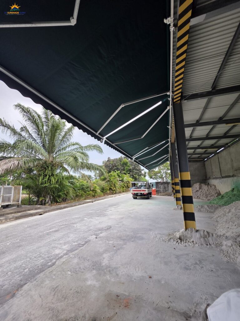 Side view of a commercial retractable awning installation for warehouse loading area in Singapore by SG Sunshade Guru.