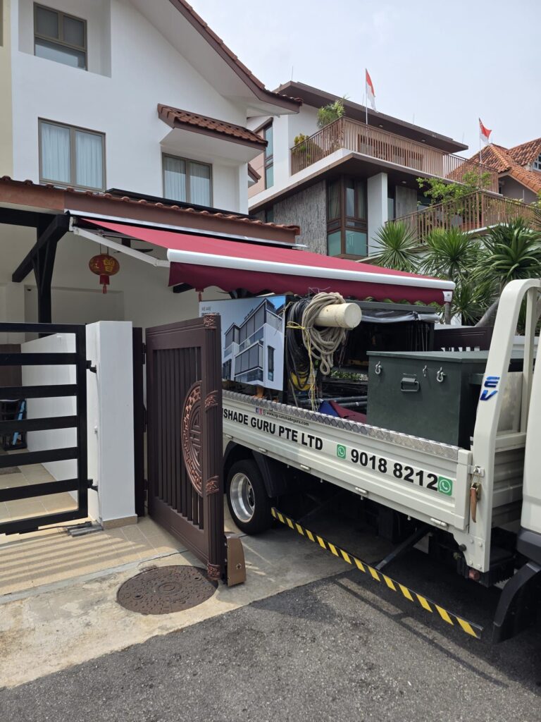 Residential retractable awning providing shade over a driveway in Singapore