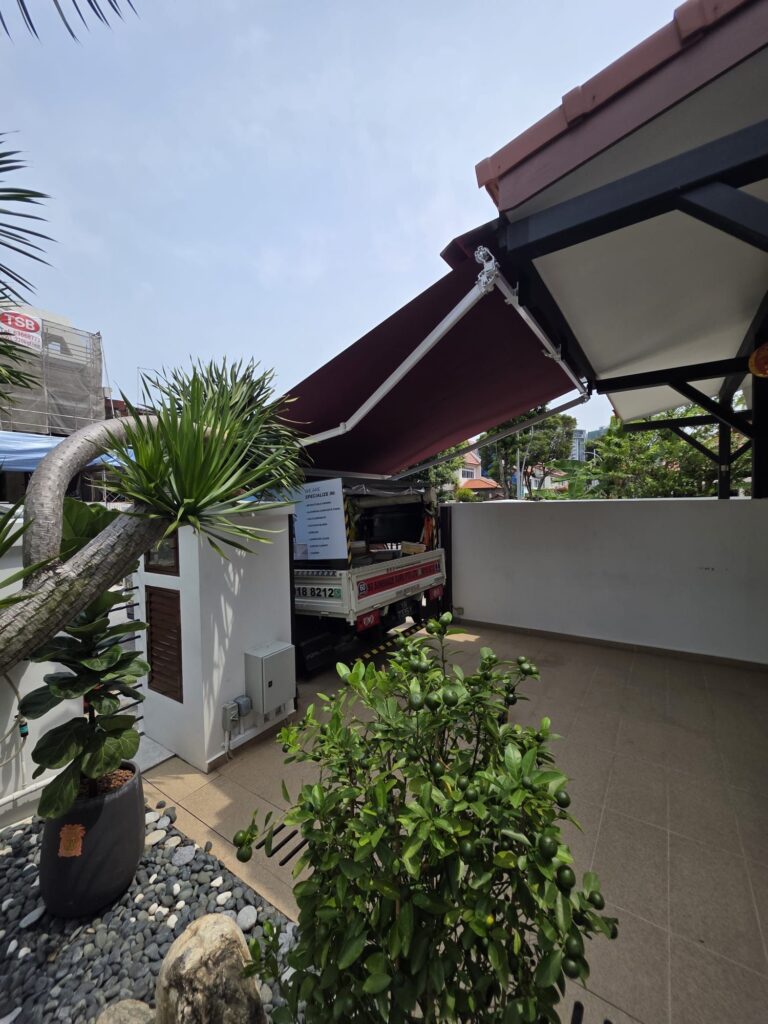 Retractable awning providing outdoor shade at a Singapore home
