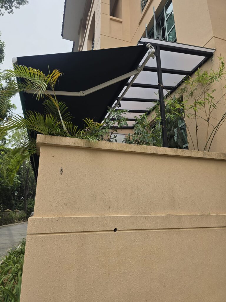 Motorised retractable awning installed beneath a frosted polycarbonate roof