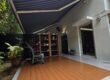 Retractable awning providing shade over an outdoor deck at a residential home in Singapore