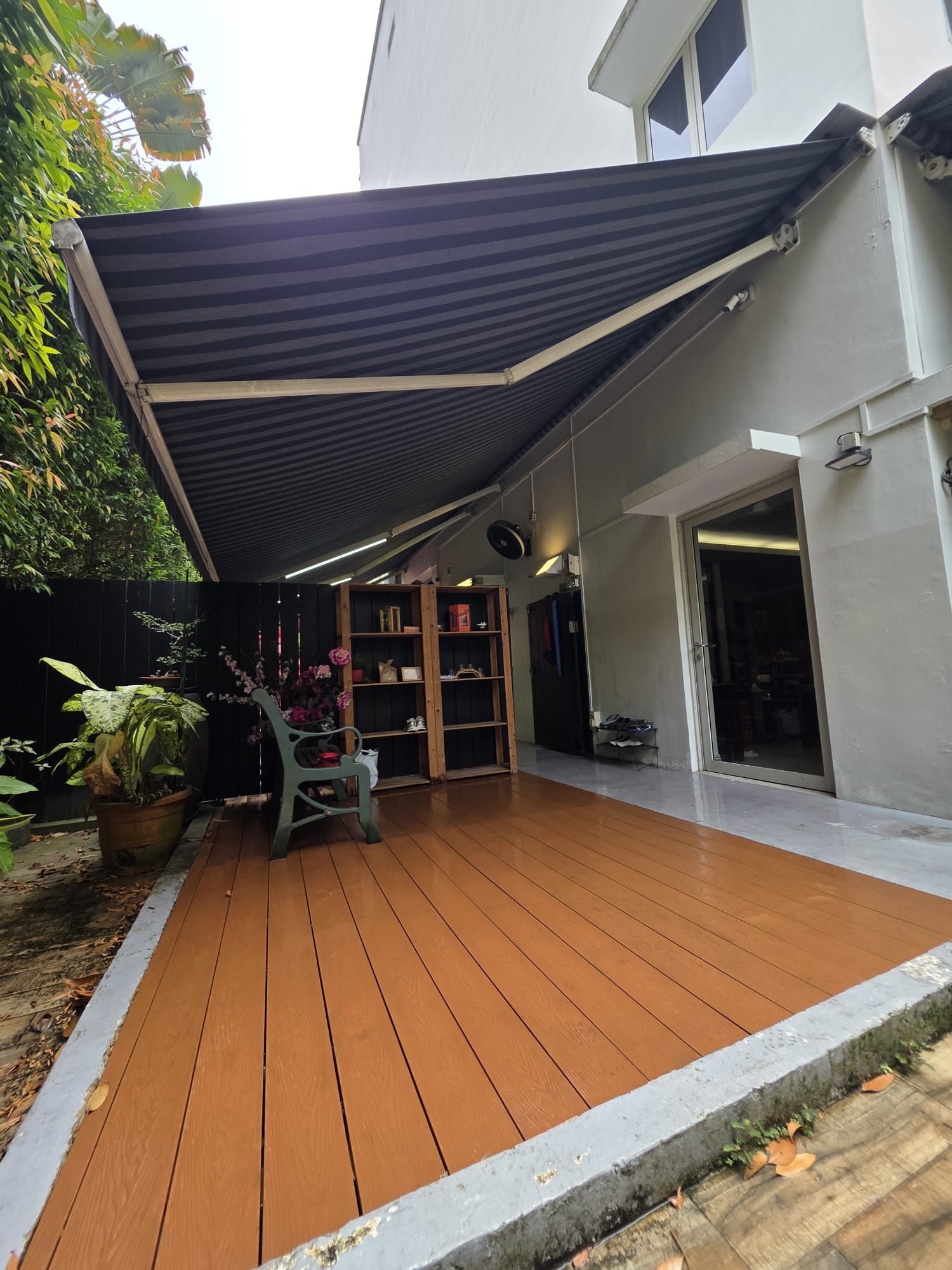 Retractable awning providing shade over an outdoor deck at a residential home in Singapore
