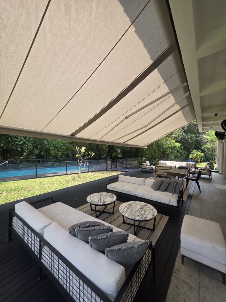 Wide retractable awning installed along the exterior of a residential property