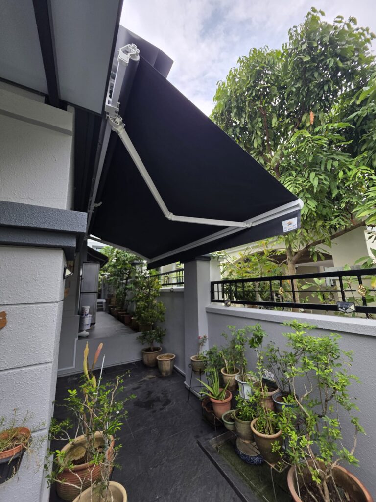 Black retractable awning extended over a residential patio area