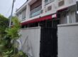 Red retractable awning extended over a sheltered outdoor area