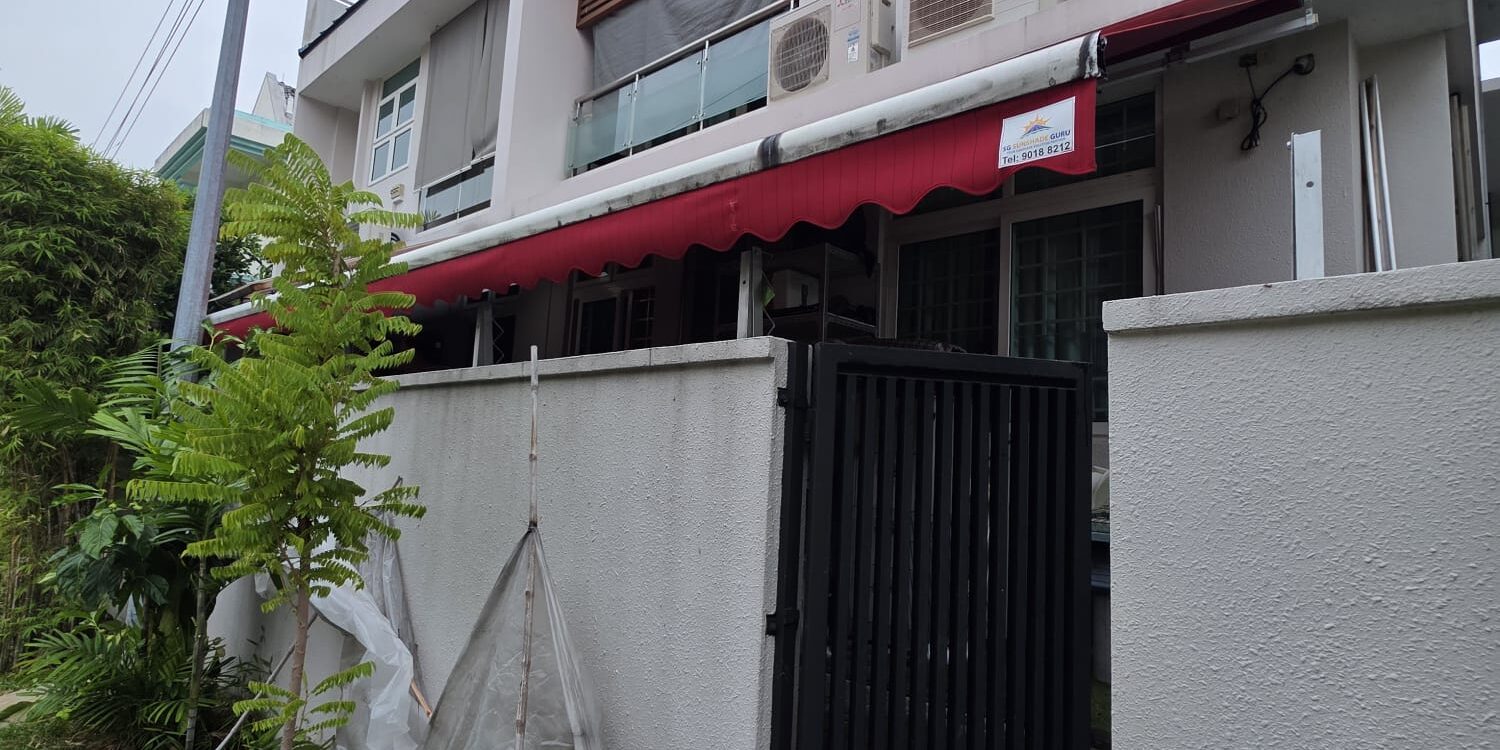 Red retractable awning extended over a sheltered outdoor area