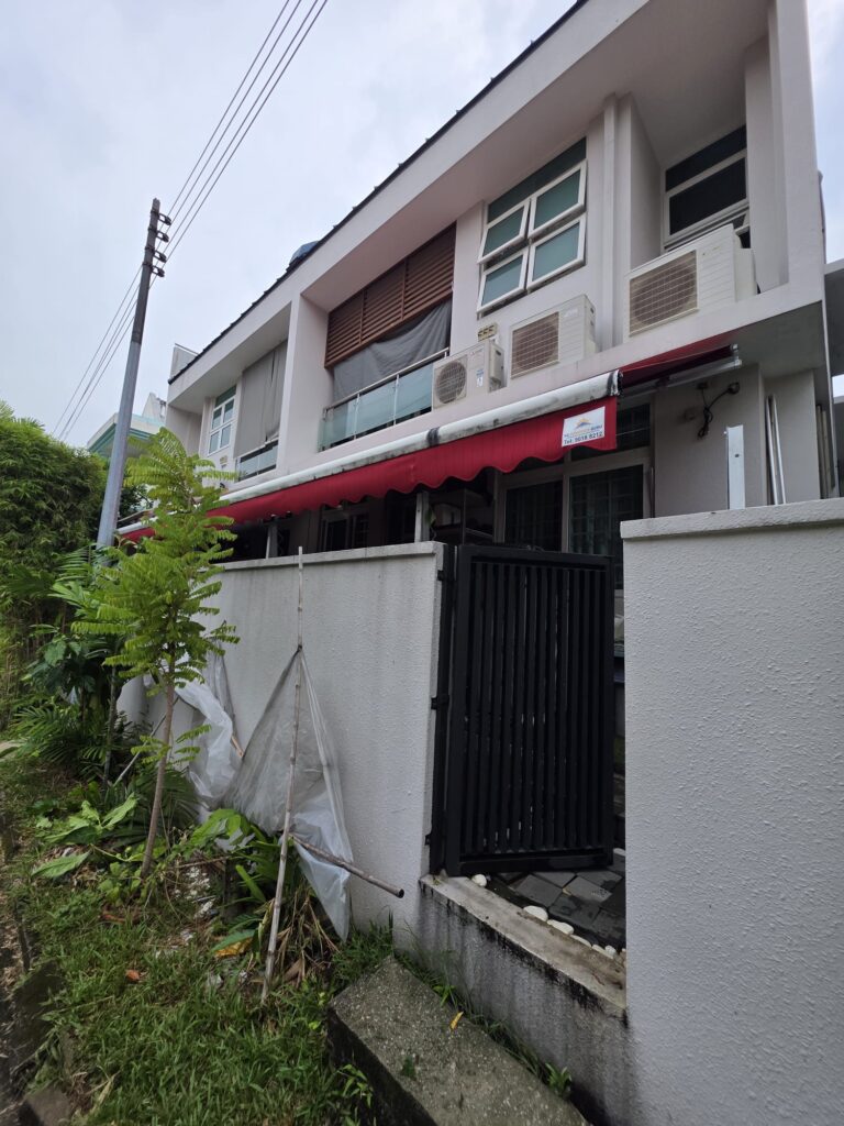 Red retractable awning extended over a sheltered outdoor area
