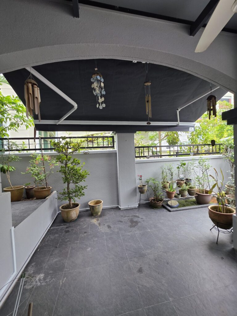 Retractable awning providing shade over the patio of a residential home in Singapore
