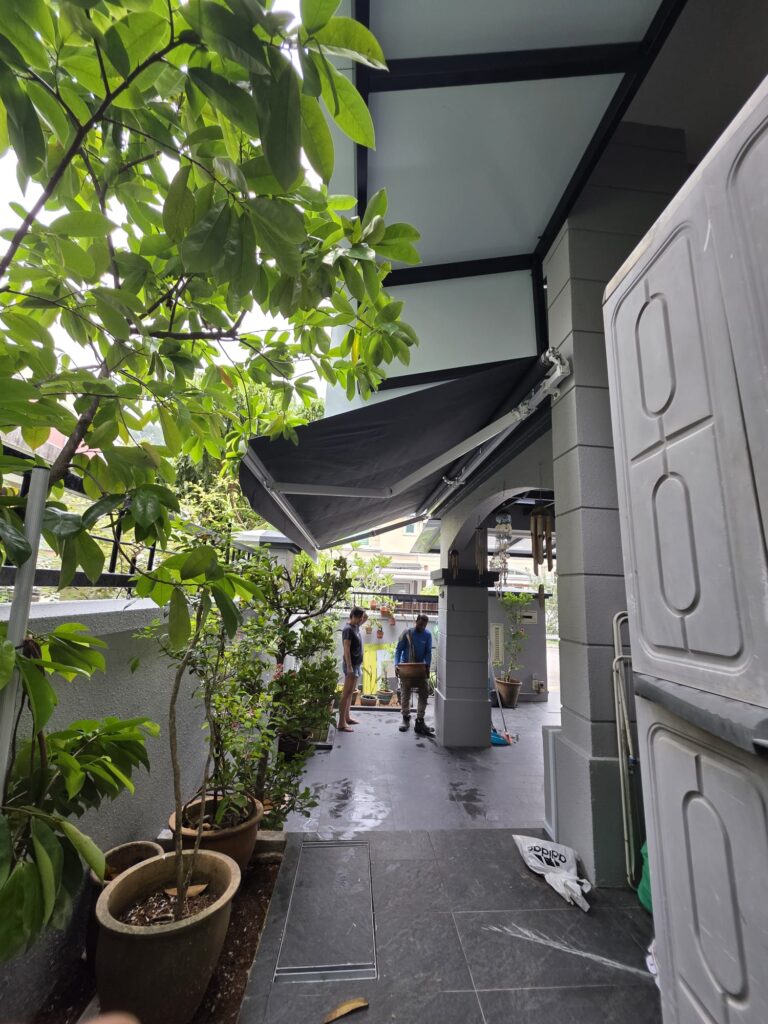 Extended retractable awning creating shade over an outdoor patio