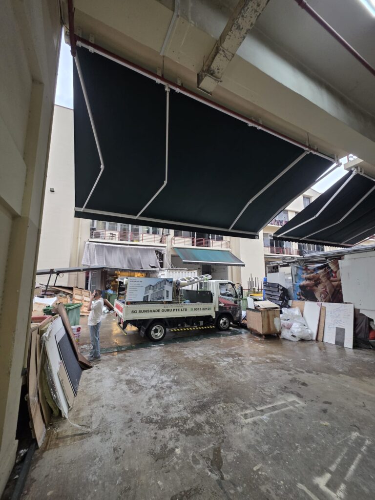 Retractable awning extended over a residential patio with potted plants